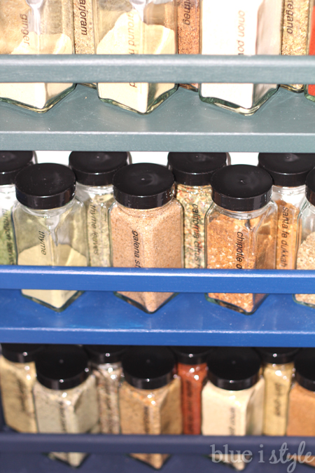 Ombre colored spice racks on pantry wall
