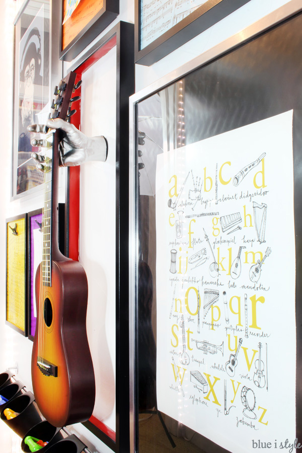I love the music alphabet poster and he hanging guitar on rock & roll gallery wall in this playroom.