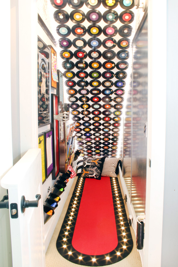 UNDER STAIRS PLAYROOM. The disfunctional storage space under the basement stairs was transformed into a rock & roll themed kids playroom under the stairs. This music themed play space includes a music gallery wall, a wall covered in vinyl records, DIY sheet music wallpaper, and a magnetic ping pong ball wall maze.