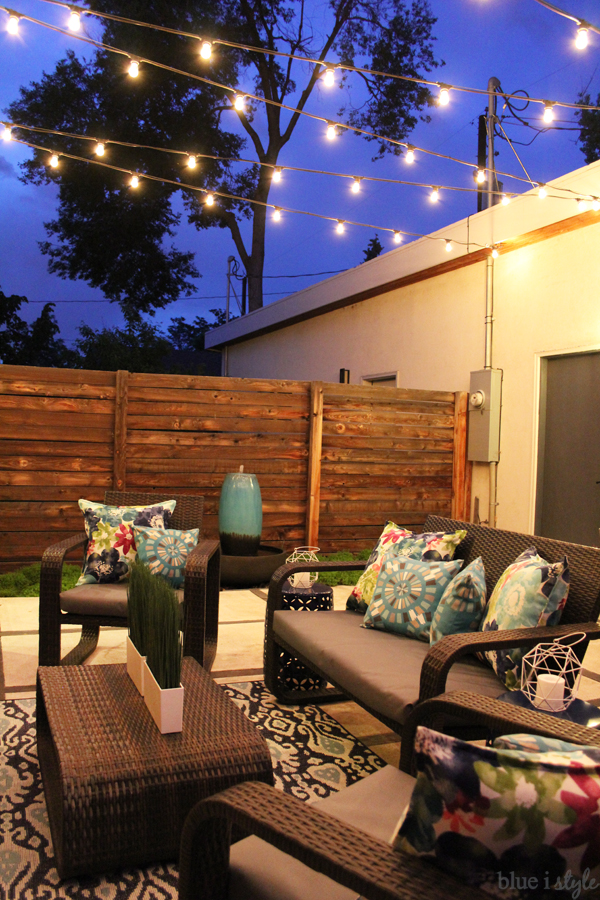 String lights above patio at dusk