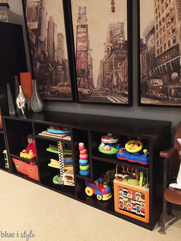 Toys stored on open shelves in family room