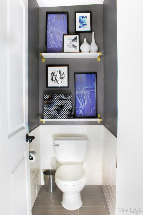 Dark Grey Water Closet with faux marble shelves and art