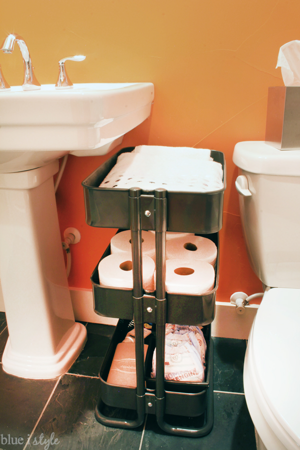 Use an Ikea Raskog Cart to create storage next to a pedestal sink