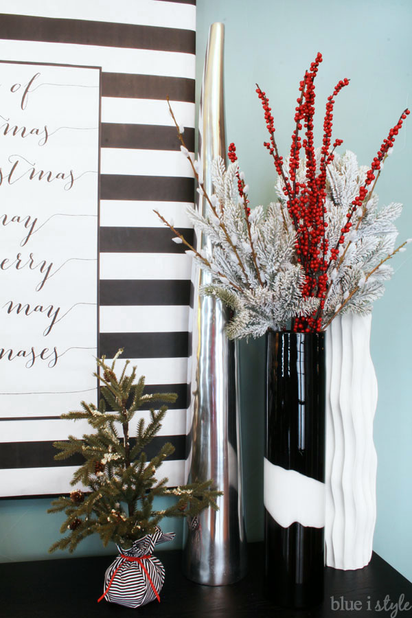 Christmas branches in tall vase