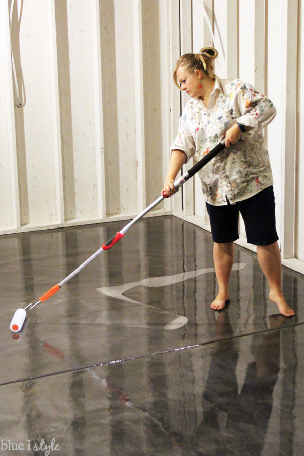 rolling clear top coat with anti-slip additive onto metallic floor