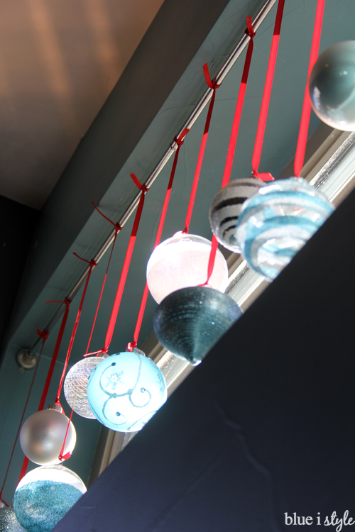 Hang breakable ornaments out of kids' reach for a safe Christmas display Hang Christmas ornaments in window