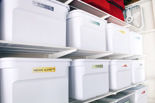 Elfa shelving in garage with matching white storage bins