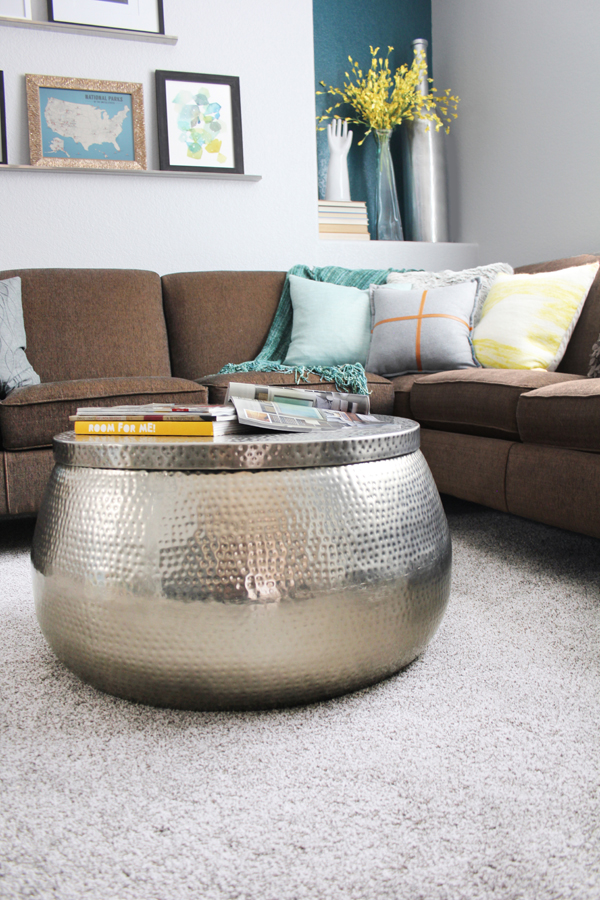 Gray carpet in family room with brown couch