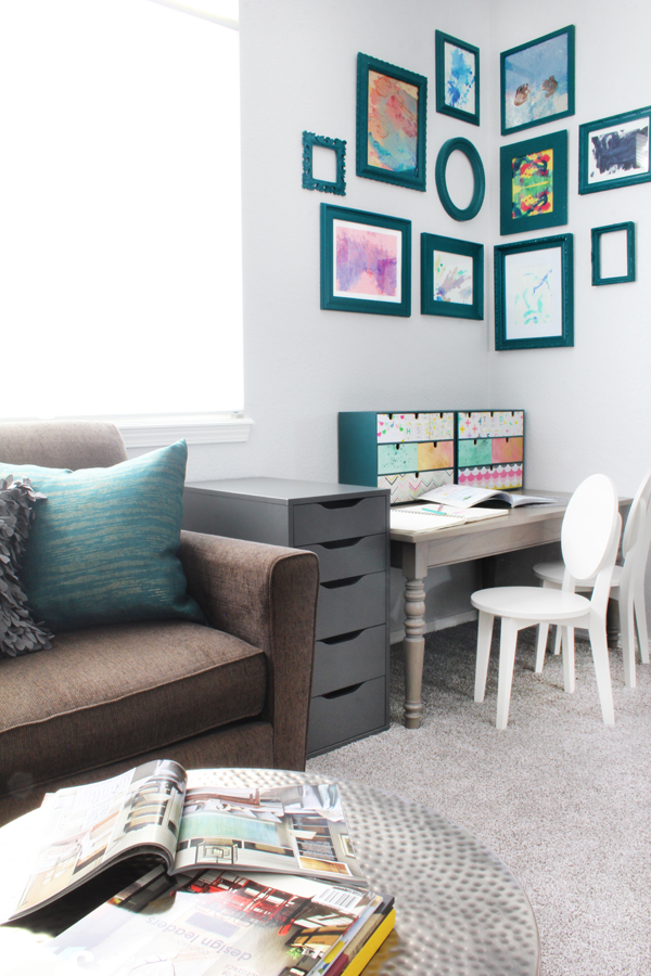 Art table in family room corner gallery wall kids' art