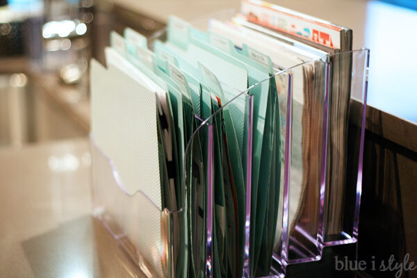 Sort school paperwork on kitchen counter