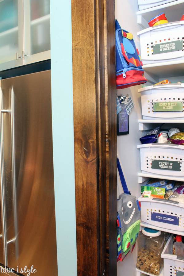 Lunch boxes hanging on wall of pantry