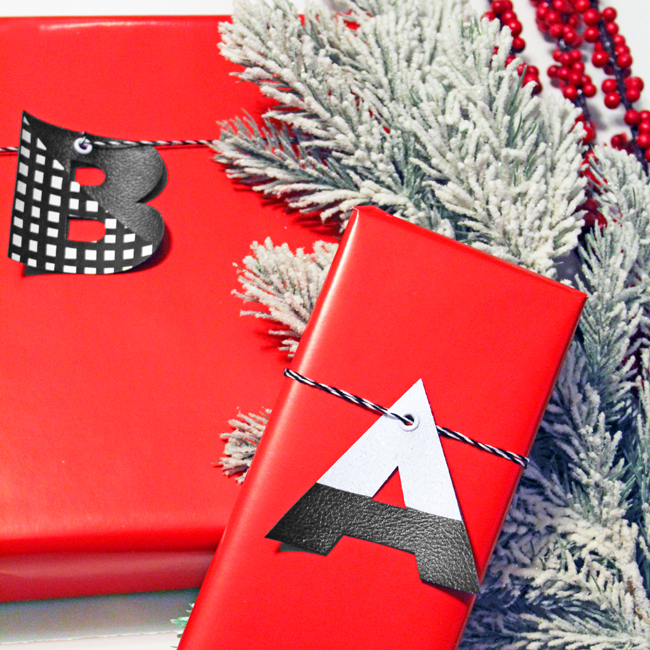 Reusable Monogram Gift Tags in Leather Red wrapped gifts with large faux leather monogram letter tags in black, white and gingham on black twine