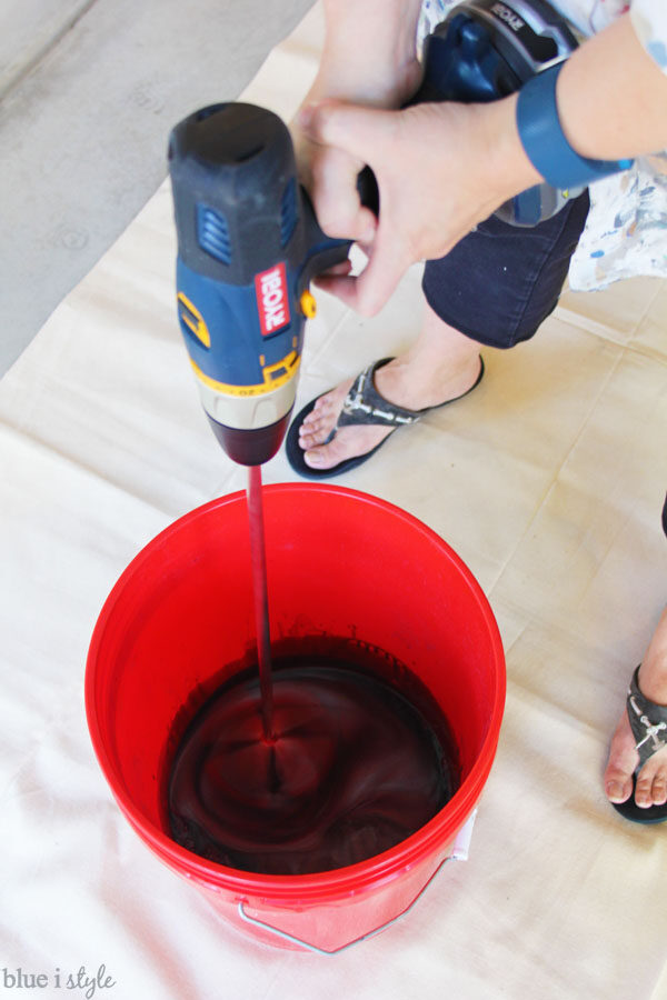 Mixing RockSolid metallic coating for garage floor with paddle mixer