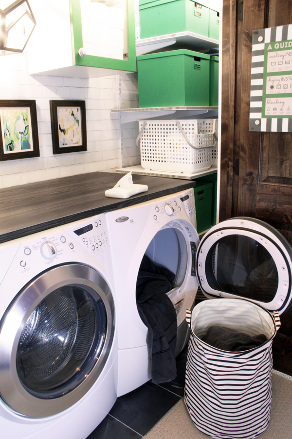 Laundry closet with black and white striped laundry basket