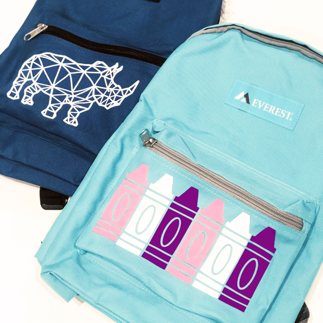 Square photo of backpack with rhino and backpack with crayons