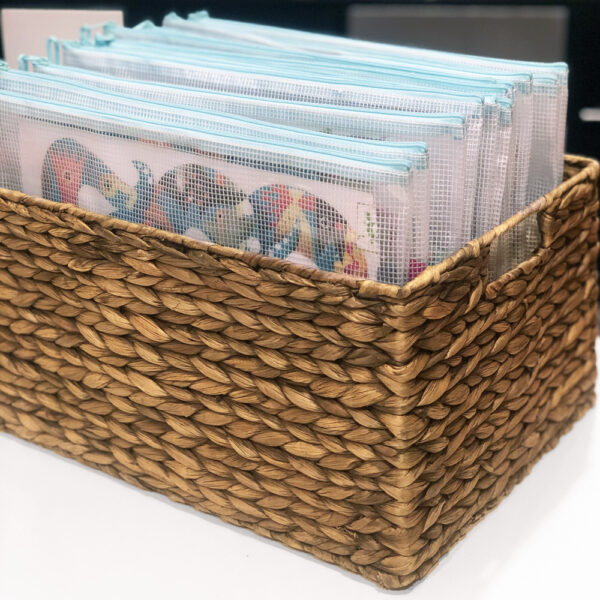 Organized puzzles in zipped pouches in a basket
