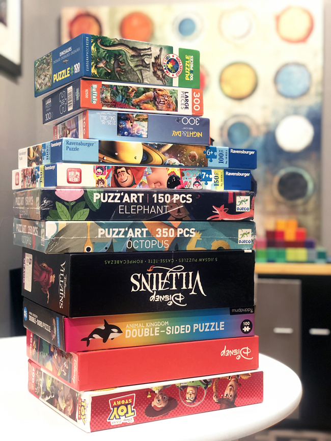 Stack of jigsaw puzzles in boxes 