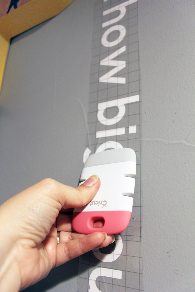 Burnishing vinyl wall quote using Cricut scraper tool