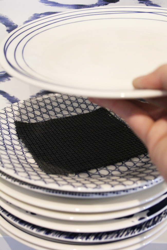 shelf liner between stack of blue and white salad plates