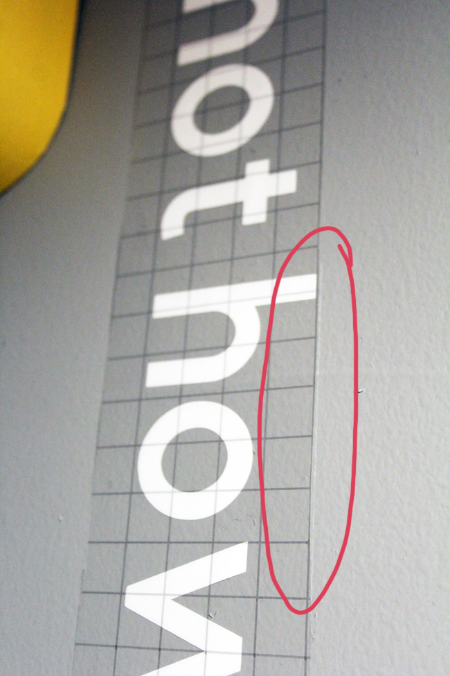 Lining up Cricut transfer tape guidelines with level line to apply wall words