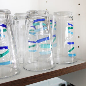 Shelf Liner in Kitchen Cabinet with Blue Teal Striped Drinking Glasses