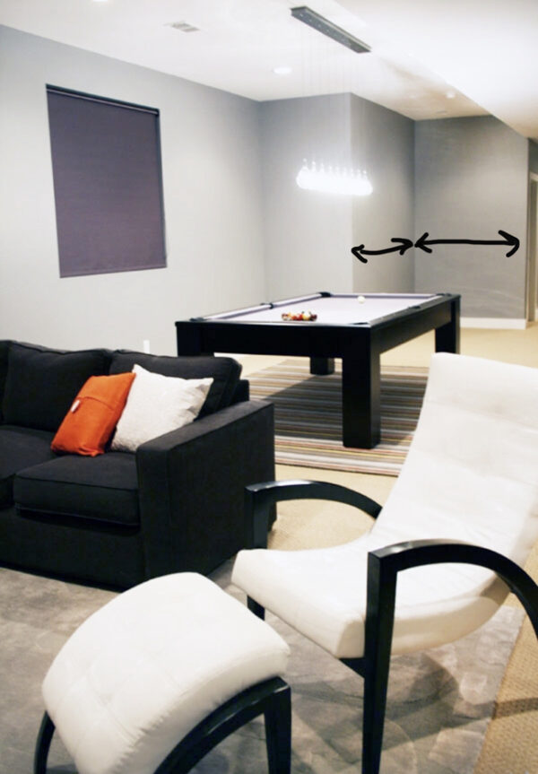 Basement with gray walls, gray couch, and a pool table with gray felt